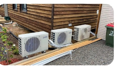 Outdoor air conditioner compressor units installed beside a building