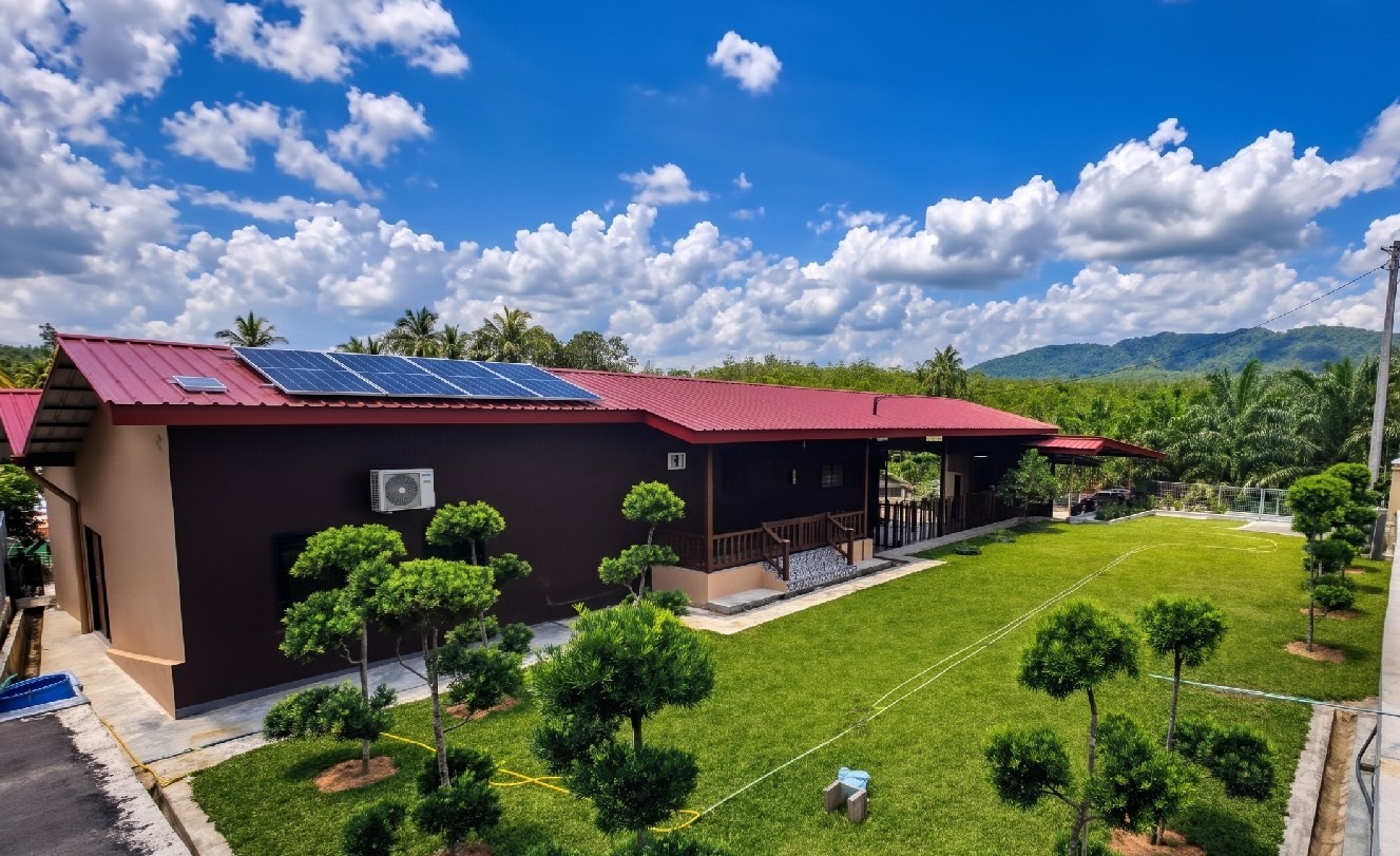 Resort-style building with solar panels on a red roof
